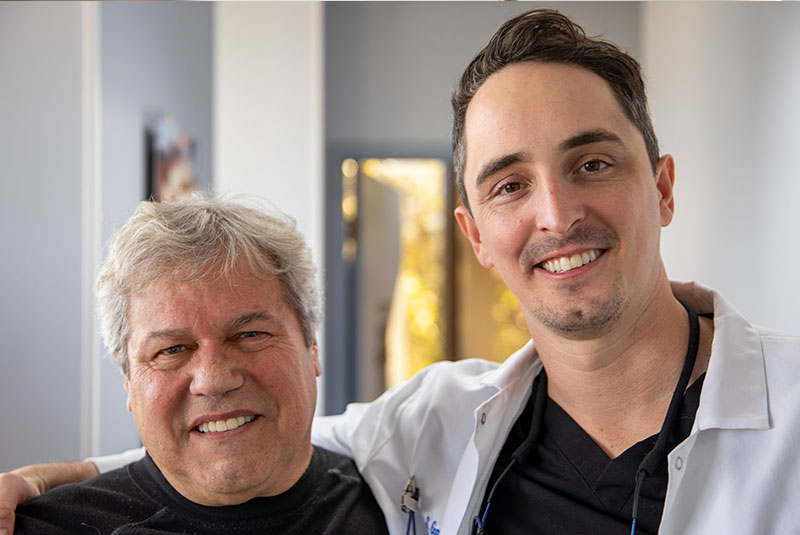 Doctor and Patient smiling after patient dental implant procedure