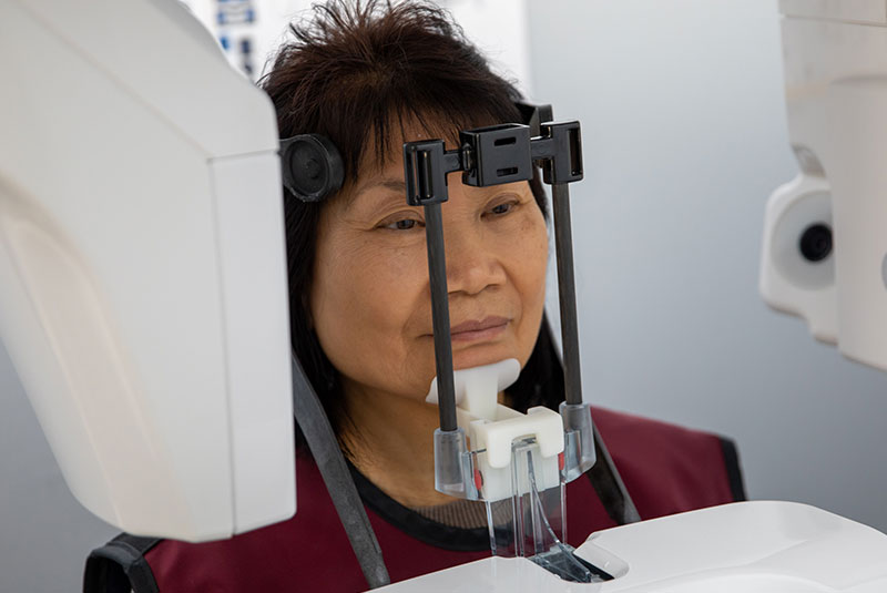 Patient having a dental 3D scan with machine for procedure