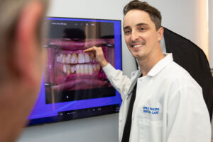 Doctor showing digital images to patient about their dental procedure