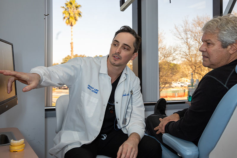 Doctor going over dental implant procedure with patient